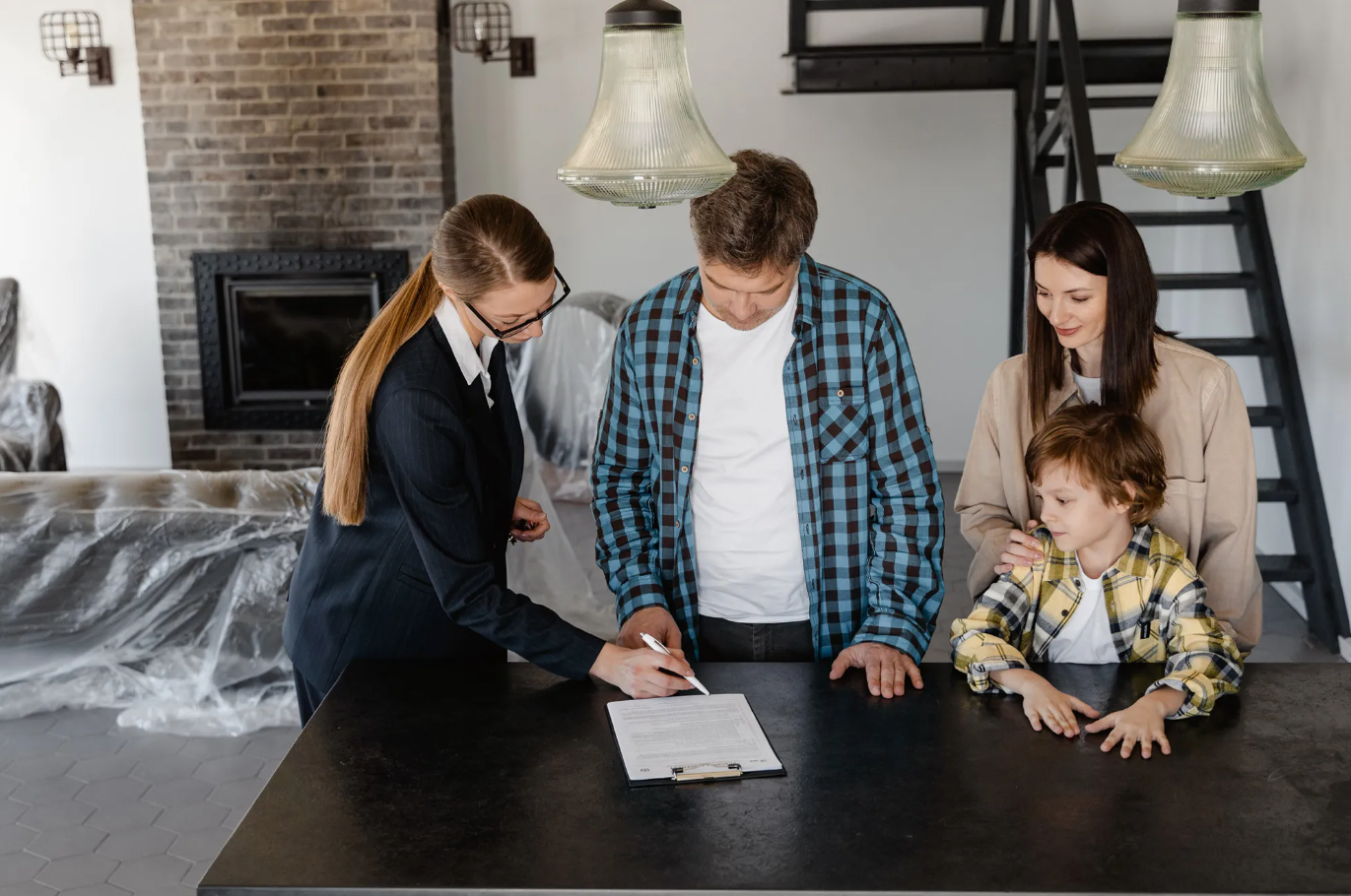 Family signing contract with real estate agent.