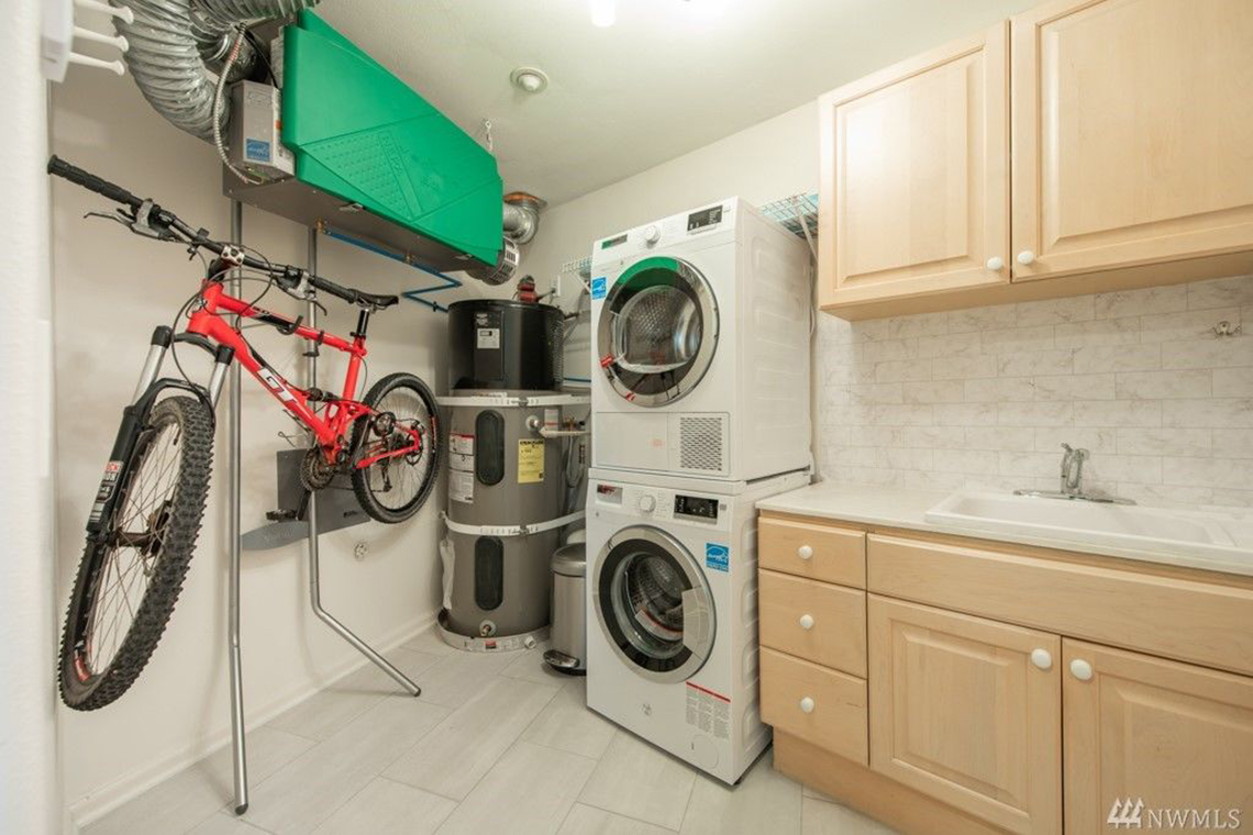 McGraw Built Green 4-Star Seattle condo remodel utility room with bike rack and heat pump hot water heater