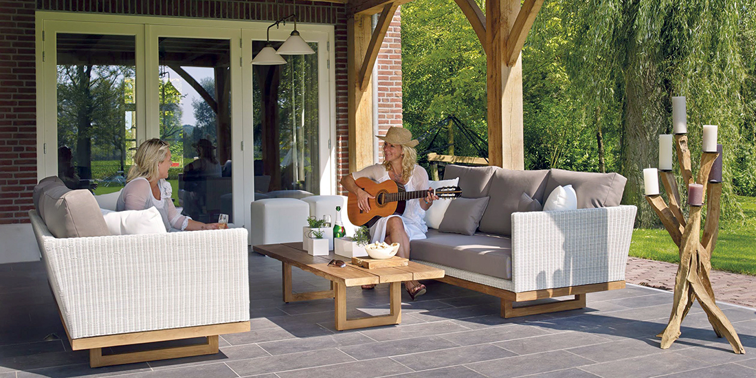 Two women relaxing on a paver patio